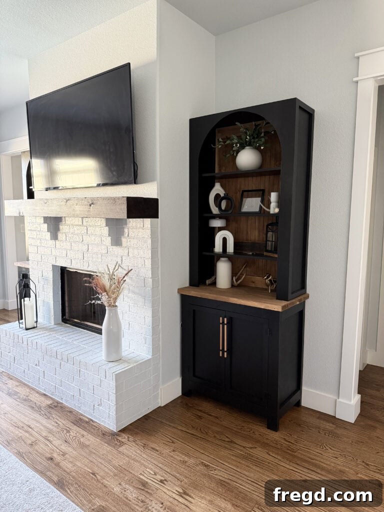 Another view of the DIY arched bookcases integrated into the living room decor.