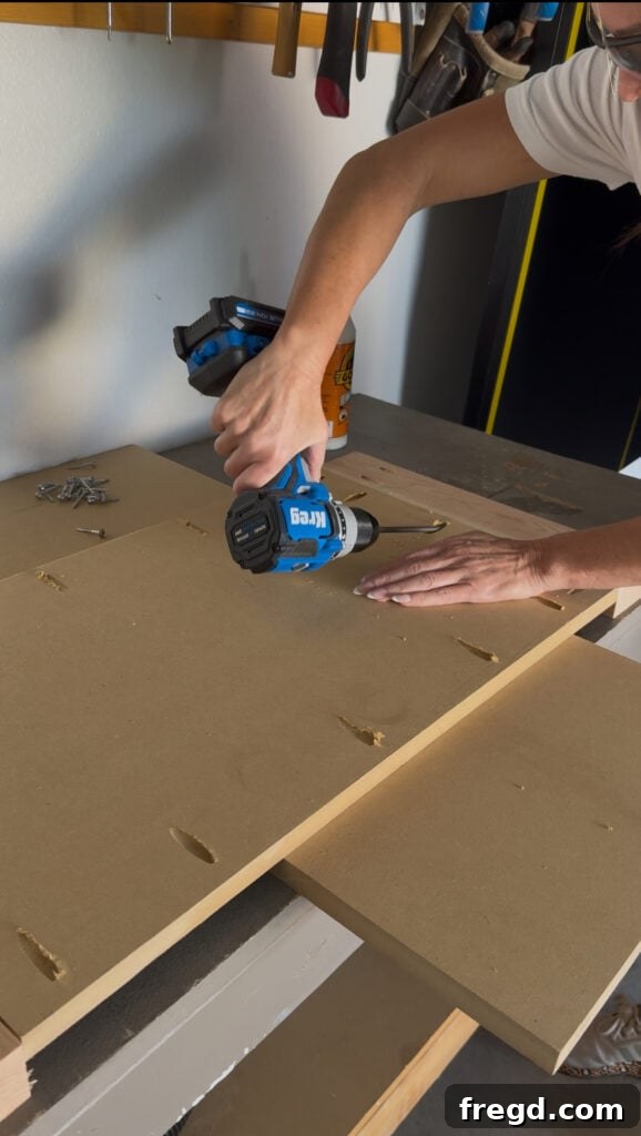 Assembling the side panel and apron pieces with wood glue and pocket hole screws.