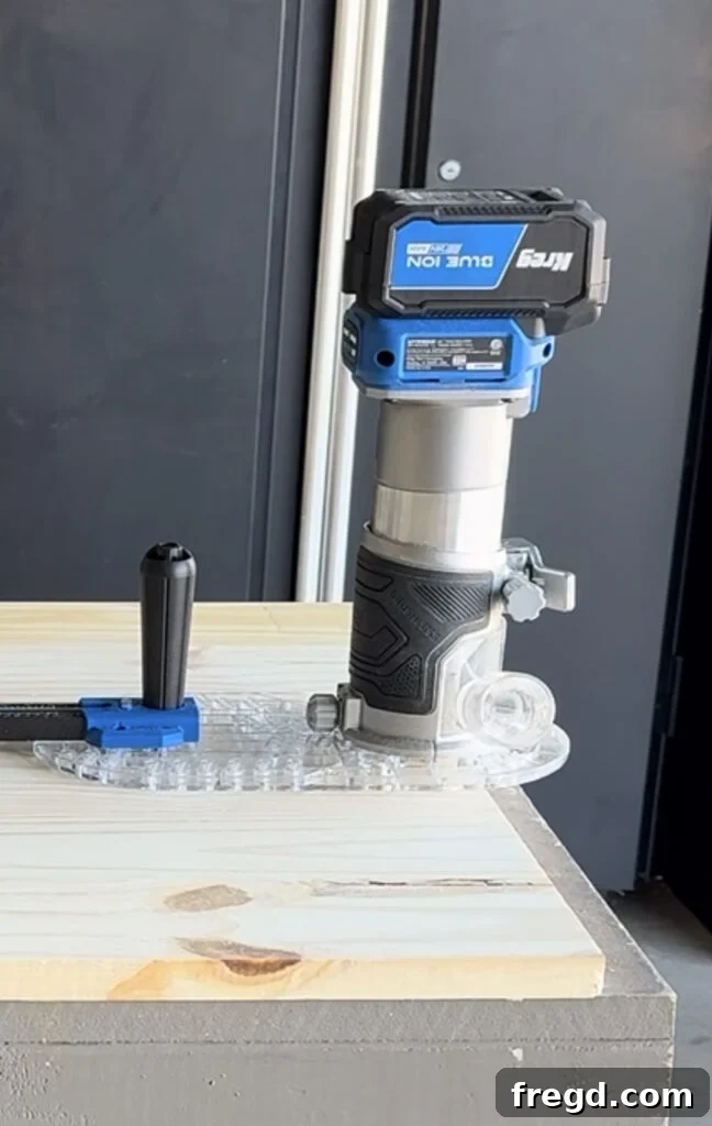 The Kreg Trim Router being held, showcasing its ergonomic design.